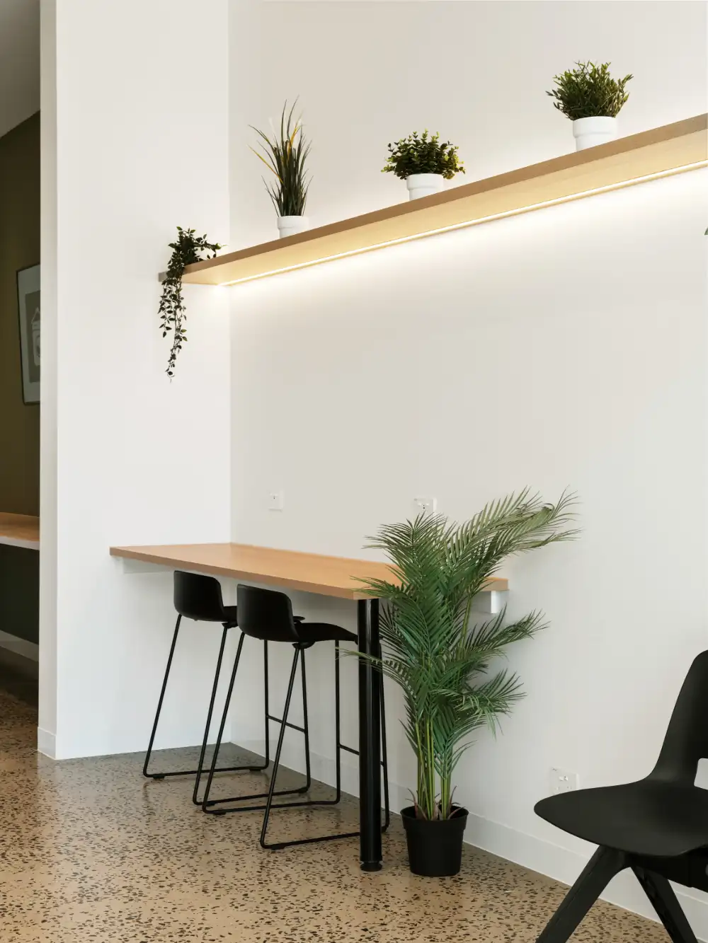 The bright, welcoming interior of Fresh Lab Laundromats in Maylands — timber bench, bar stools and plants